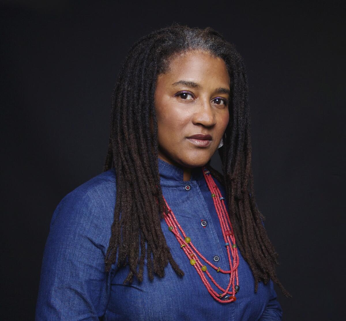 A woman looks at the camera.