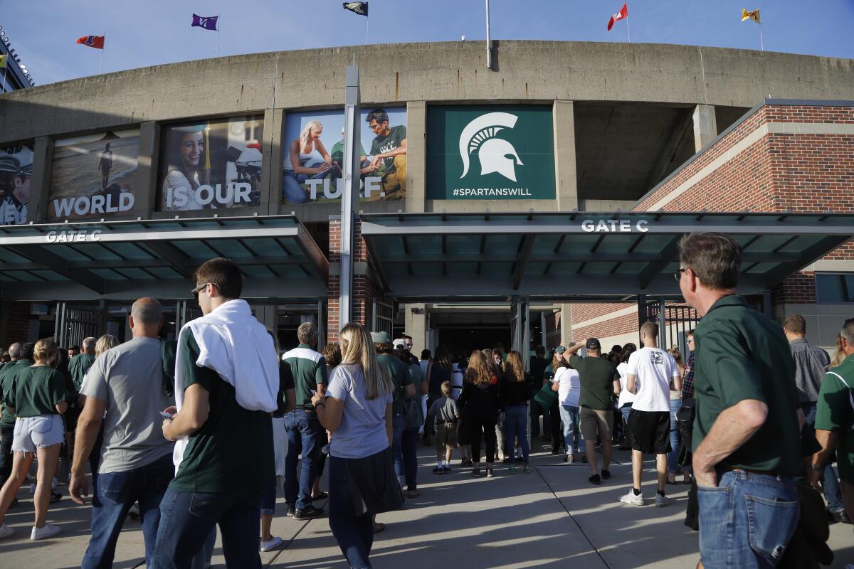 Michigan State fans wait to enter Spartan Stadium before a game in August 2019.