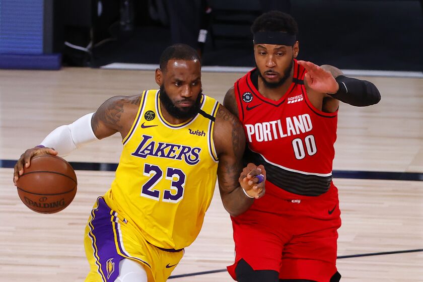 Lakers forward LeBron James drives on Portland Trail Blazers forward Carmelo Anthony during Game 2.