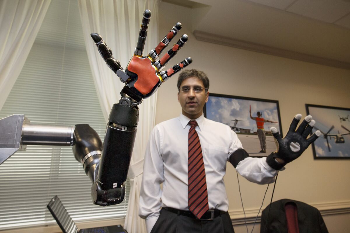 An engineer demonstrates a robotic hand 