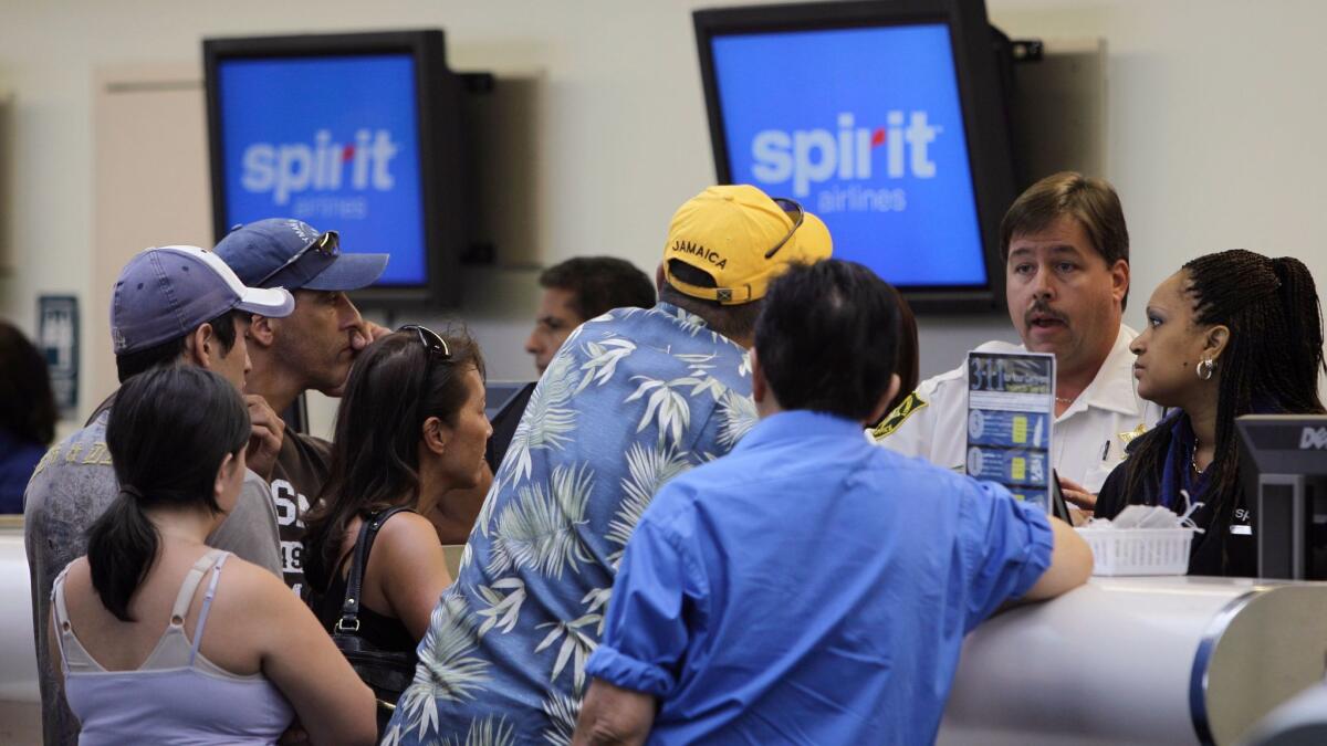 Stranded passengers stand at the Spirit Airlines ticket counter at the Fort Lauderdale-Hollywood International Airport in 2010. The airline has turned to the Disney Institute to help improve customer service.