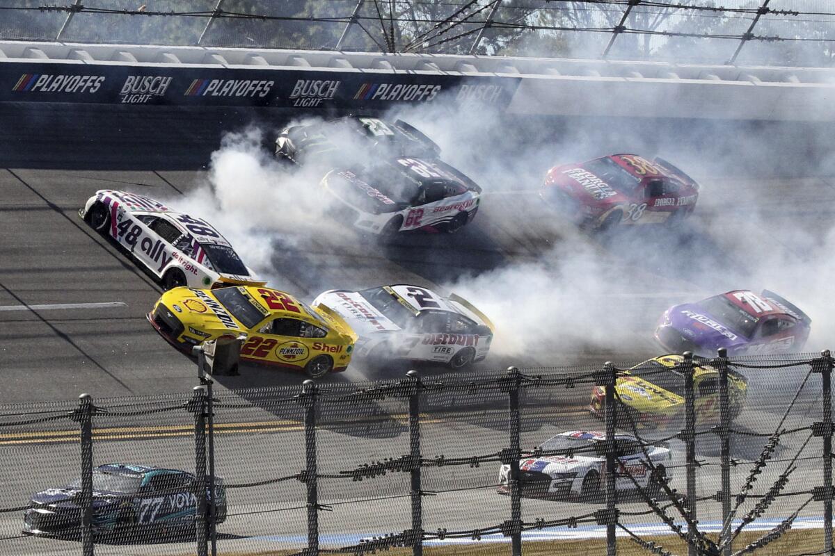 Alex Bowman (48), Joey Logano (22), Austin Cindric (2), Justin Allgaier (62) and Ty Gibbs (23) are involved in a crash in Turn 1 during a NASCAR Cup Series auto race Sunday, Oct. 2, 2022, in Talladega, Ala. (AP Photo/Skip Williams)