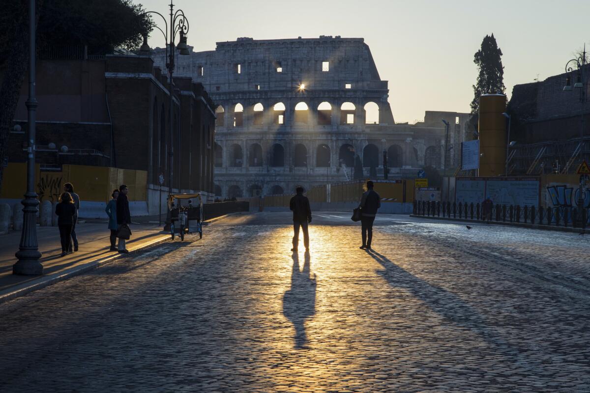 Rays of the sun create a play of light through the Colosseum during sunrise on Christmas Day.