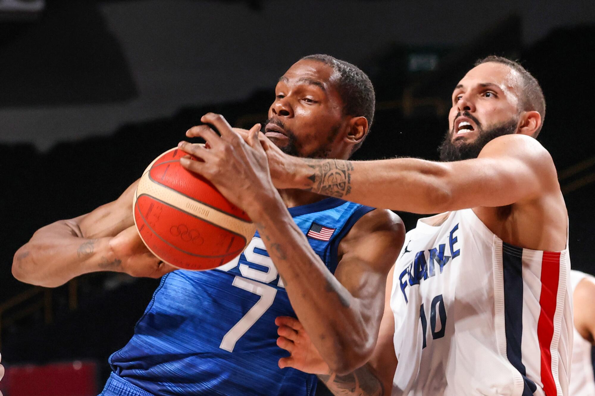 Team France shooting guard Evan Fournier knocks the ball from Team United States forward Kevin Durant