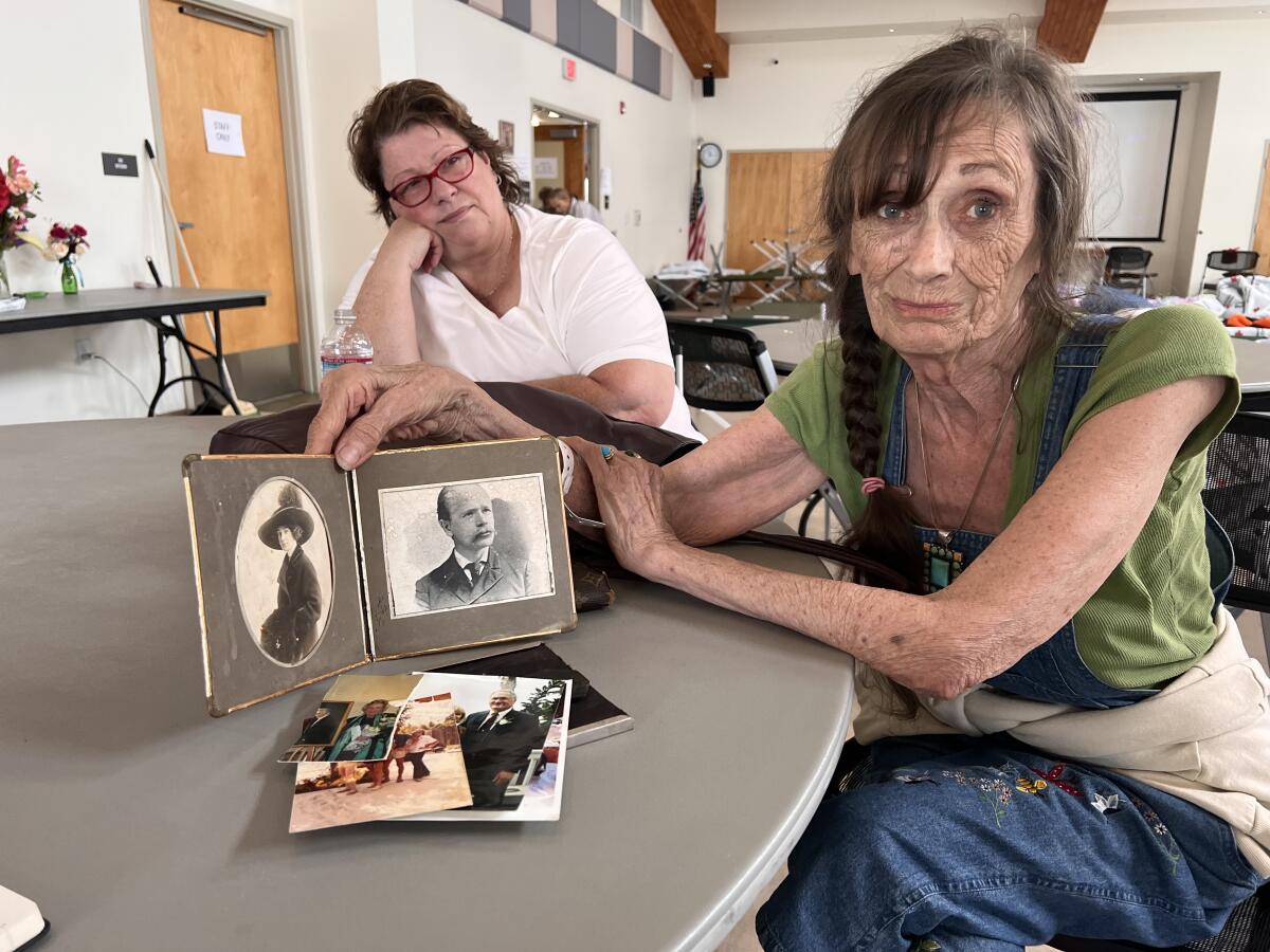 A woman shows photos of her family.