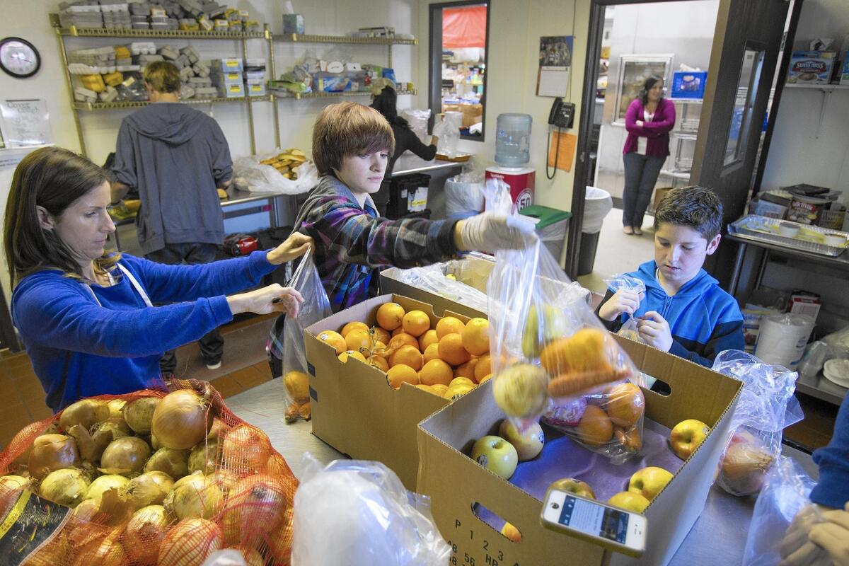 Volunteers sort fruits and vegetables during a Share Our Selves food drive in Costa Mesa.