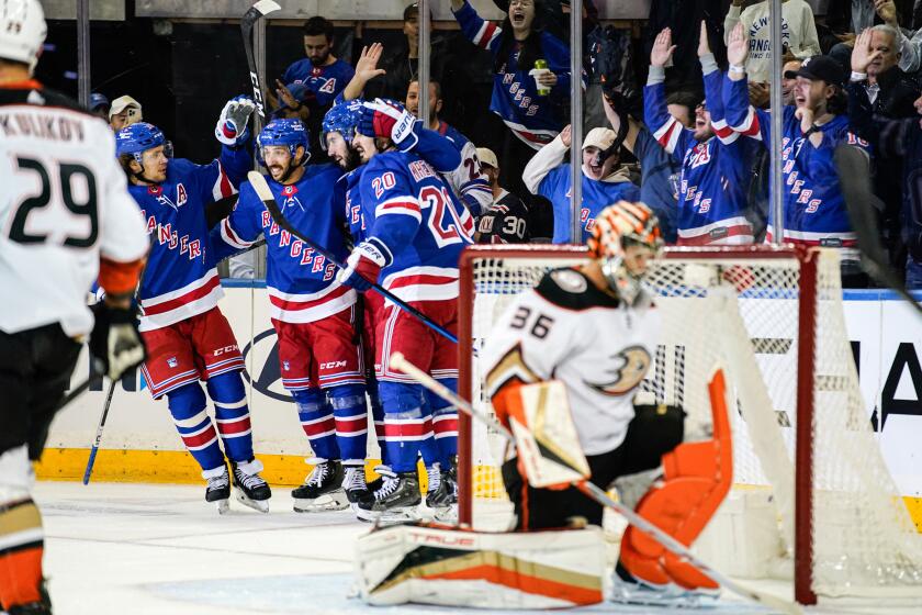 New York Rangers center Vincent Trocheck (16), left wing Chris Kreider (20) and others celebrate center Mika Zibanejad's (93) goal during the first period of an NHL hockey game against the Anaheim Ducks, Monday, Oct. 17, 2022, in New York. (AP Photo/Julia Nikhinson)