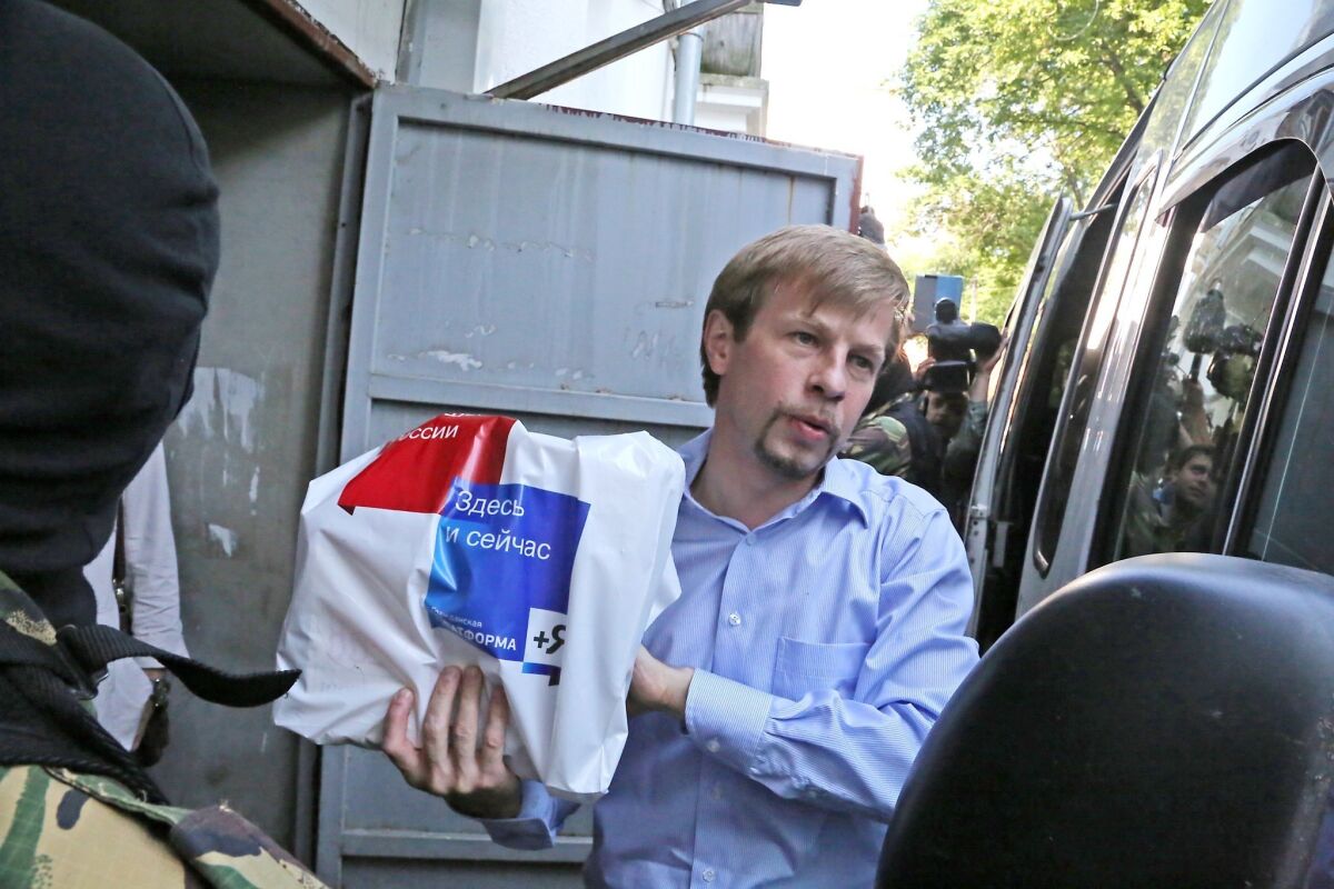 Yaroslavl Mayor Yevgeny Urlashov is escorted by police Wednesday.