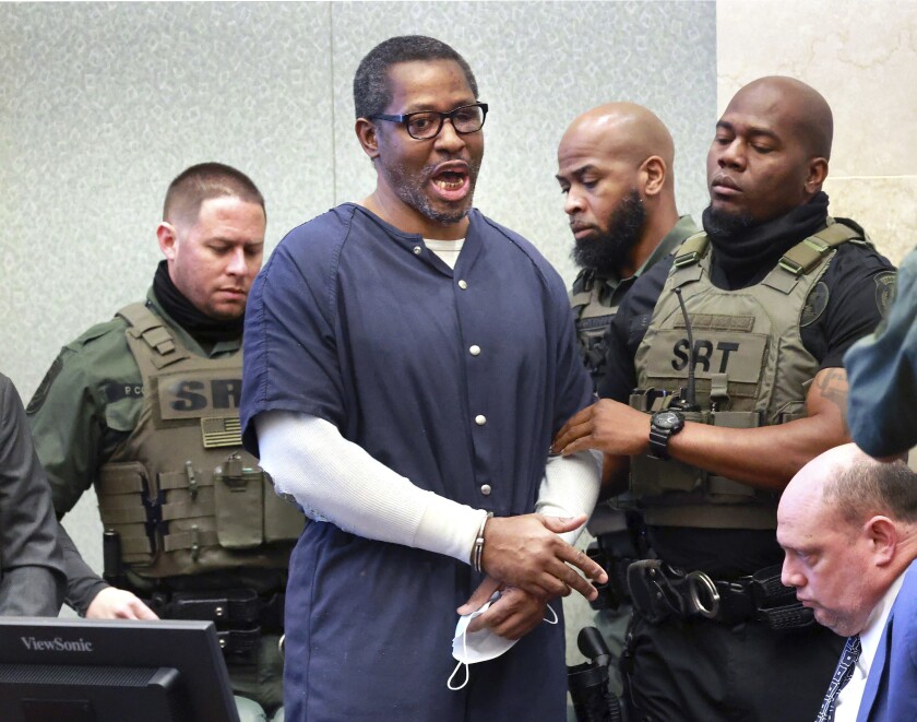 Markeith Loyd, convicted of killing Orlando police Lt. Debra Clayton in 2017, shouts at the gallery as deputies remove him from the courtroom after he was sentenced to death in Orange County circuit court in Orlando, Thursday, March 3, 2021. At lower right is defense attorney Terence Lenamon. (Joe Burbank/Orlando Sentinel via AP)