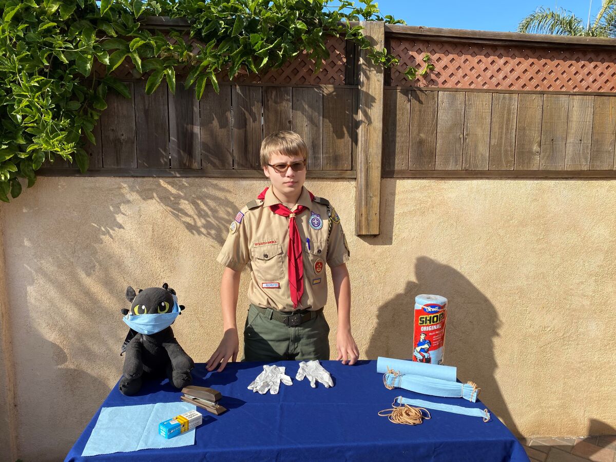 Killian Treppa, a Boy Scout in Point Loma-based Troop 500, shows the supplies he's used to make masks for his Eagle project.