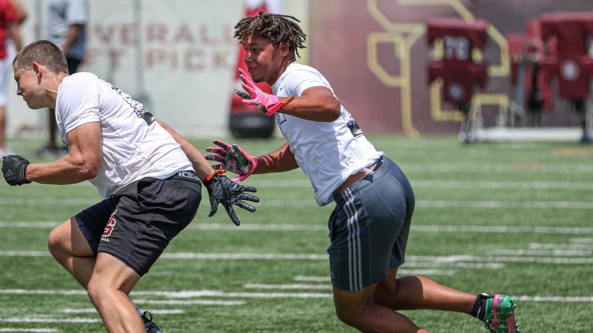 Pacifica linebacker tries to get physical with JSerra tight end Gary Morrison during a one-on-one drill at USC's Elite Camp on June 12.