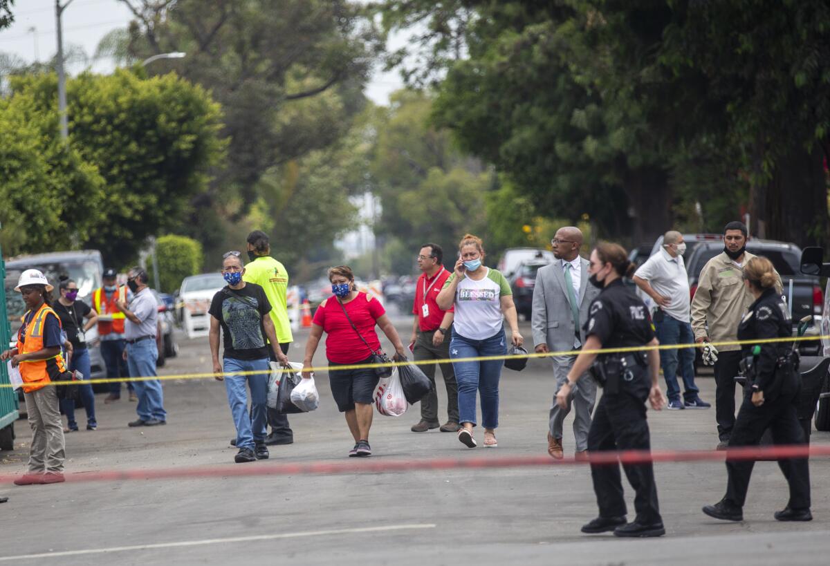 Residents are allowed back to their homes to check out the damaged on East 27th Street in Los Angeles.