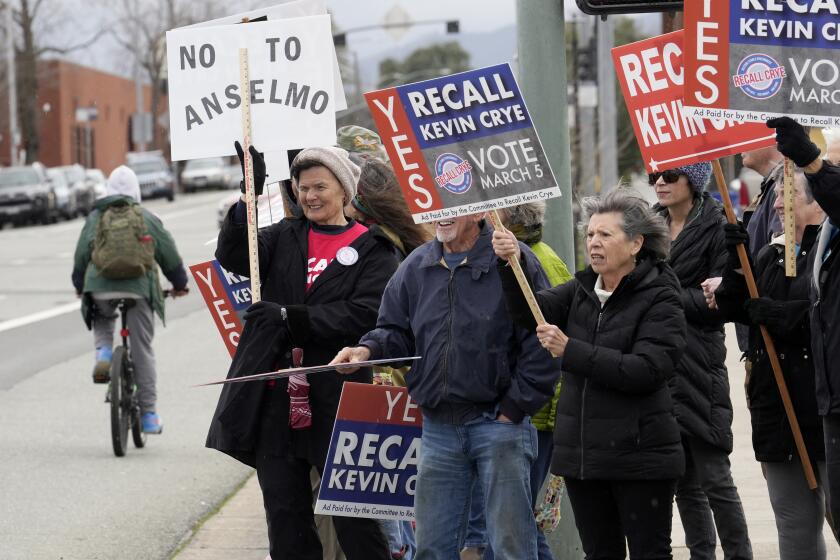 A Demonstrators calling for the recall of Shasta County Supervisor Kevin Crye, rally in Redding, Calif., on Tuesday, Feb. 20, 2024. Crye is one of the board members who voted to get rid of the county's ballot-counting machines in favor of counting ballots by hand. (AP Photo/Rich Pedroncelli)
