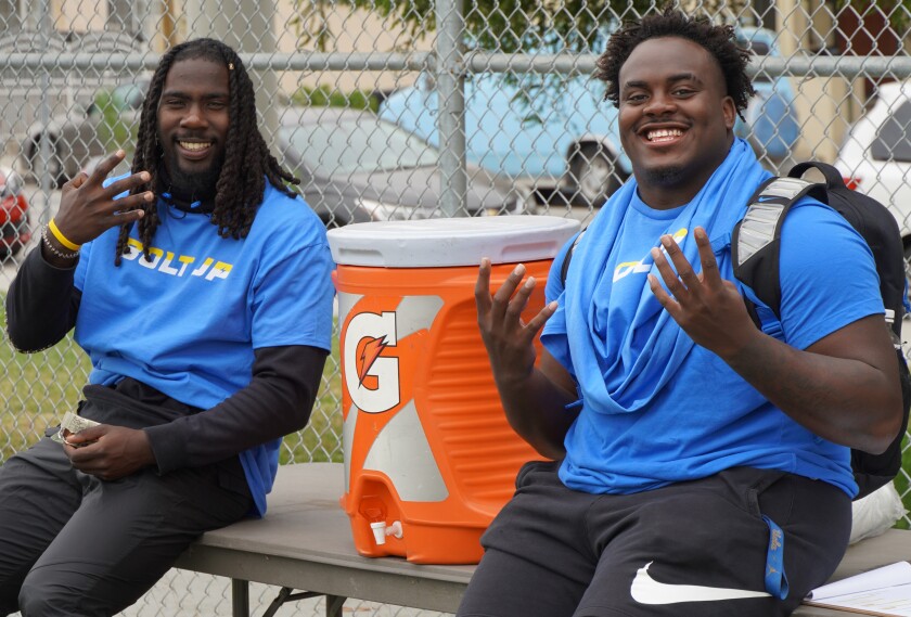 Carl Jones Jr., left, and Gary Smith III of UCLA hang out with campers.