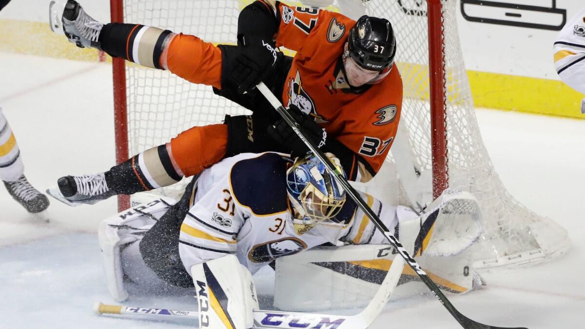 Ducks forard Nick Ritchie tumbles over Sabres goalie Anders Nilsson during the third period Friday night.