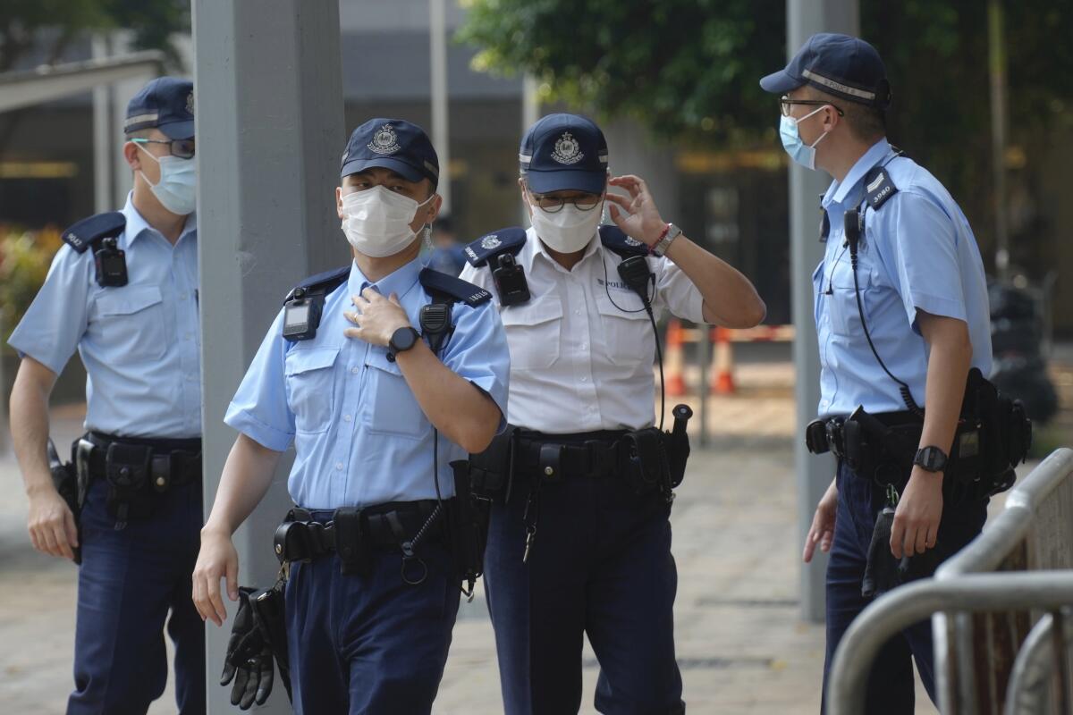 Masked police officers wait in Hong Kong