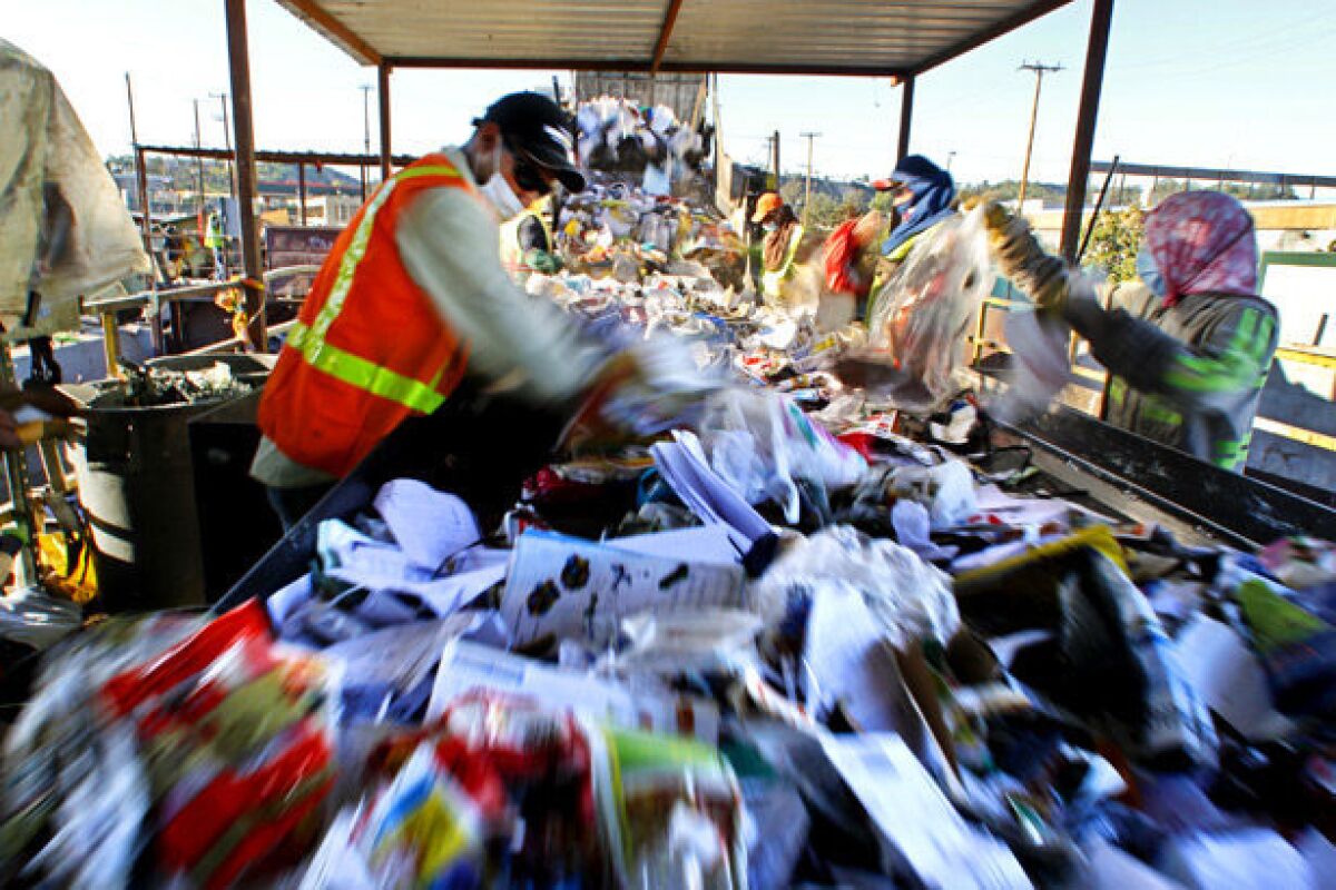 Workers sort through recyclables at Los Angeles Recycling Center.