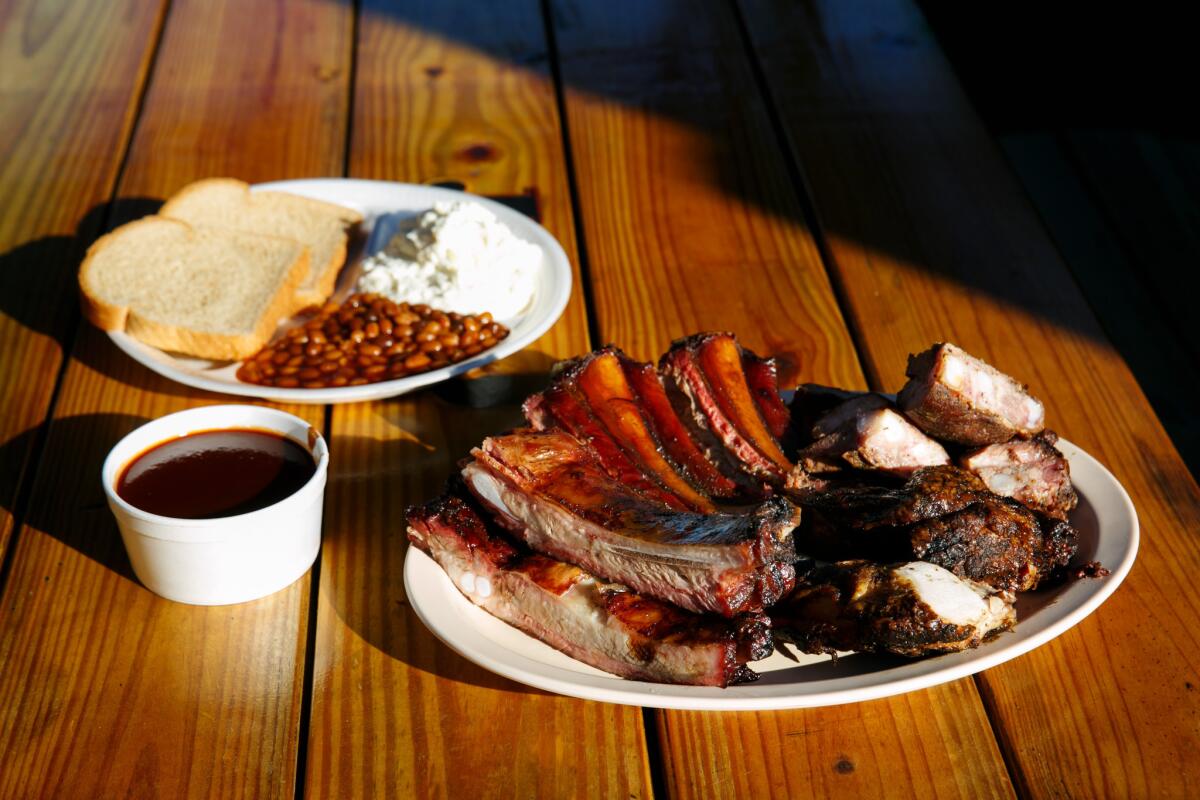 Pork ribs, pork rib tips and roast chicken are among the entrees served with a side of beans, potato salad and bread at JNJ Bar-B-Que and Burgers in South Los Angeles.