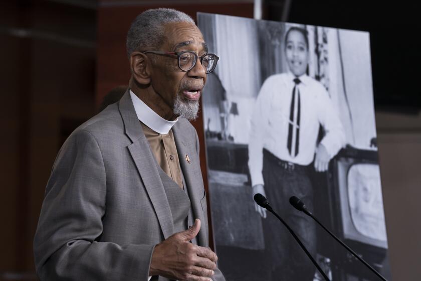 FILE - Rep. Bobby Rush, D-Ill., speaks during a news conference about the "Emmett Till Anti-Lynching Act" on Capitol Hill in Washington, on Feb. 26, 2020. Emmett Till, pictured at right, was a 14-year-old African-American who was lynched in Mississippi in 1955, after being accused of offending a white woman in her family's grocery store. Congress has given final approval to legislation that for the first time would make lynching a federal hate crime in the U.S. (AP Photo/J. Scott Applewhite, File)