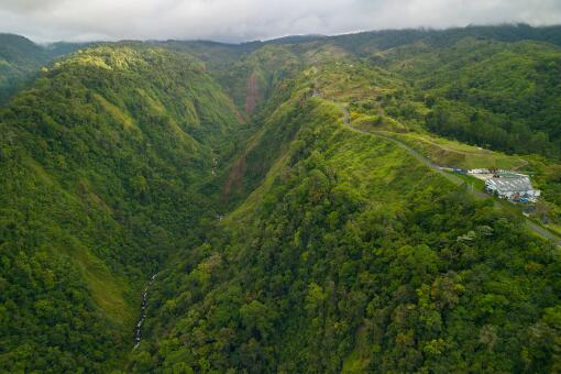 A photo of an aerial view of lush green forests covering Cinchona mountain in Heredia, Costa Rica.