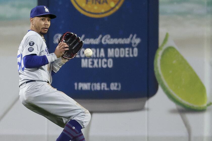 The Dodgers' Mookie Betts fields a ball hit by San Francisco's Brandon Crawford during the sixth inning Saturday night.