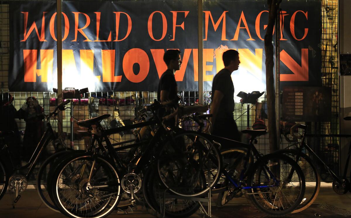 Pedestrians pass a Halloween costume store last week in Isla Vista.