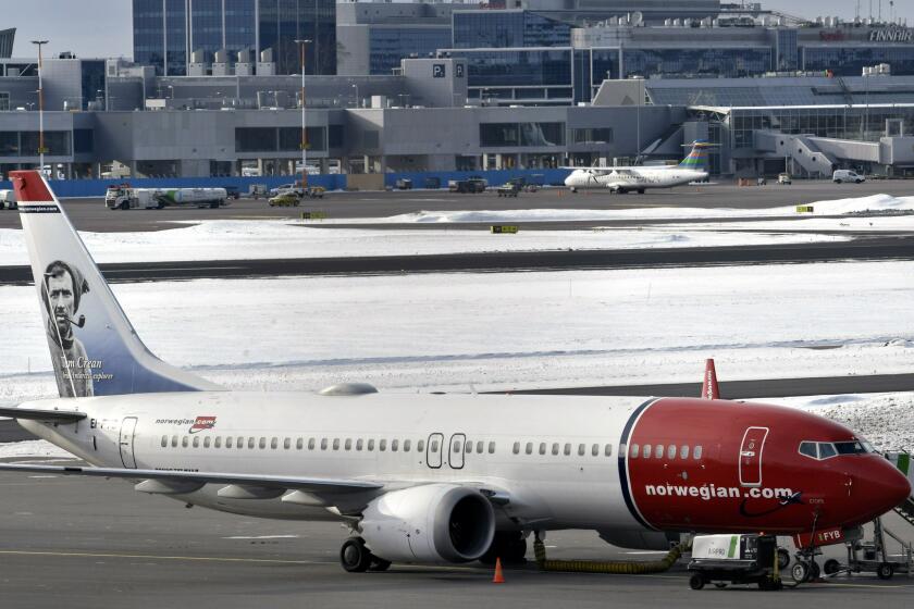 A grounded Boeing 737 MAX 8 passenger plane belonging to Norwegian airlines is parked on the tarmac at Helsinki Vantaa airport in Vantaa, Finland, Wednesday, March 13, 2019. The European Union has banned Boeing 737 MAX 8 planes from it's airspace in response to the Ethiopian Airlines crash that killed all 157 people on board. (Heikki Saukkomaa/Lehtikuva via AP)