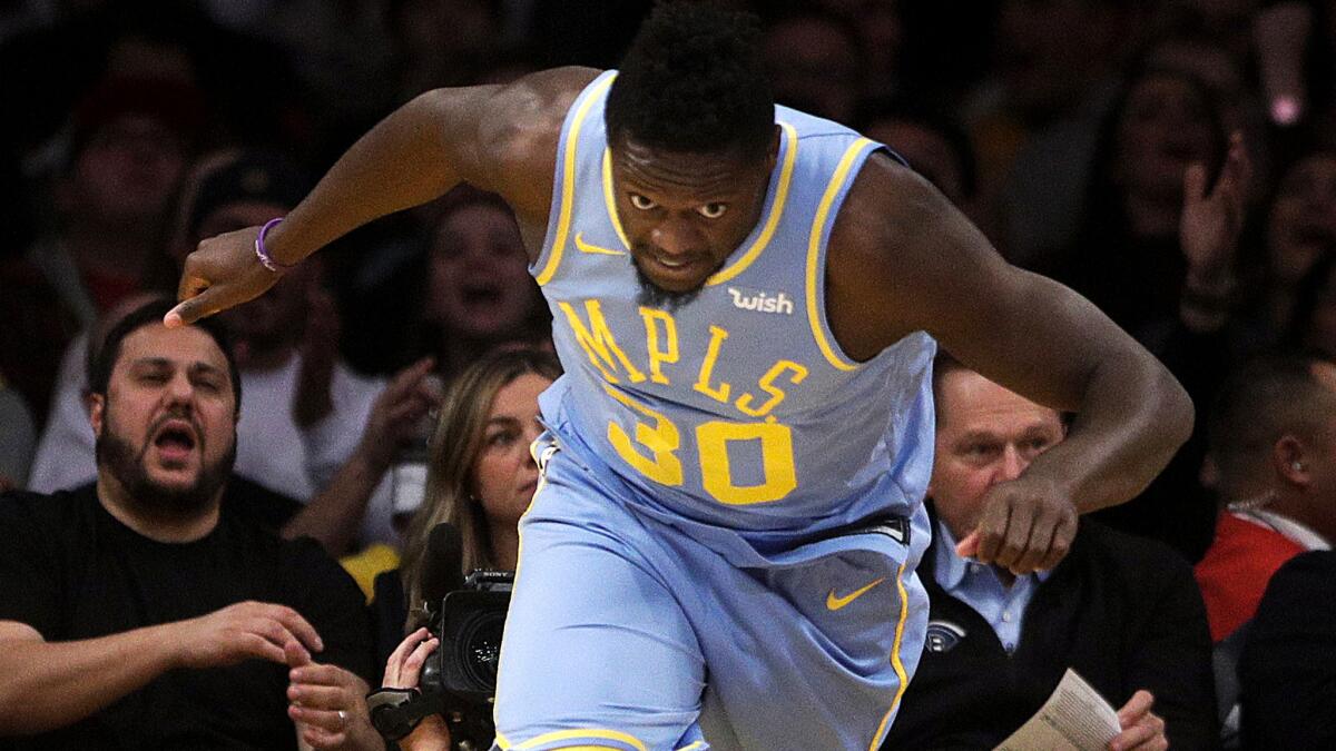 Lakers forward Julius Randle races back up court after scoring against the Grizzlies on Wednesday.