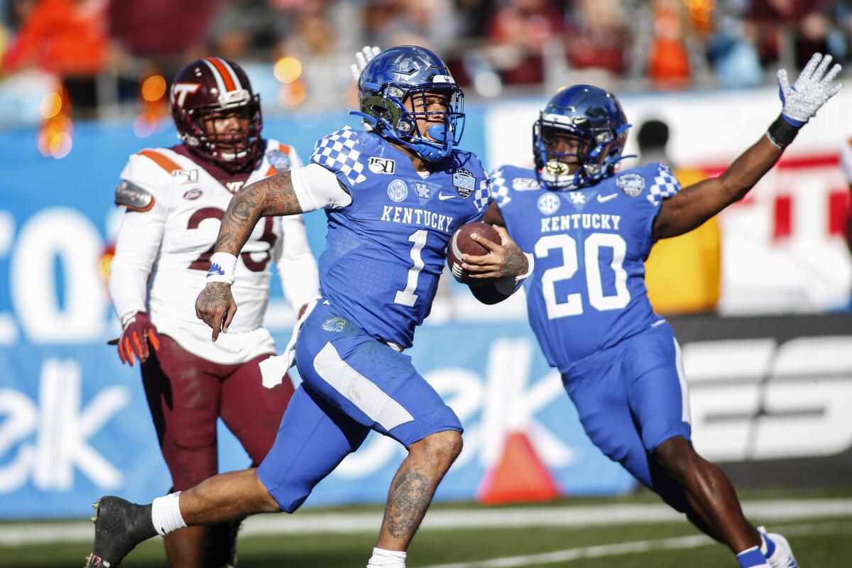 Kentucky quarterback Lynn Bowden Jr. (1) rushes for a 61-yard touchdown against Virginia Tech in the Belk Bowl.