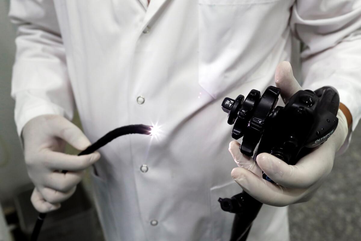 A doctor tests an endoscopy probe.