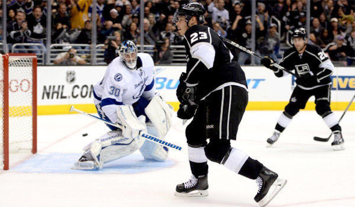 Kings captain Dustin Brown slips the puck past Lightning goalie Ben Bishop for his fourth goal of the season. The Kings defeated Tampa Bay, 5-2.