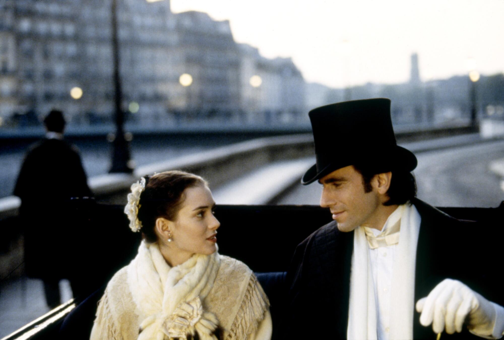 Winona Ryder and Daniel Day-Lewis, in period costume, sit in a carriage on the set of "The Age of Innocence."