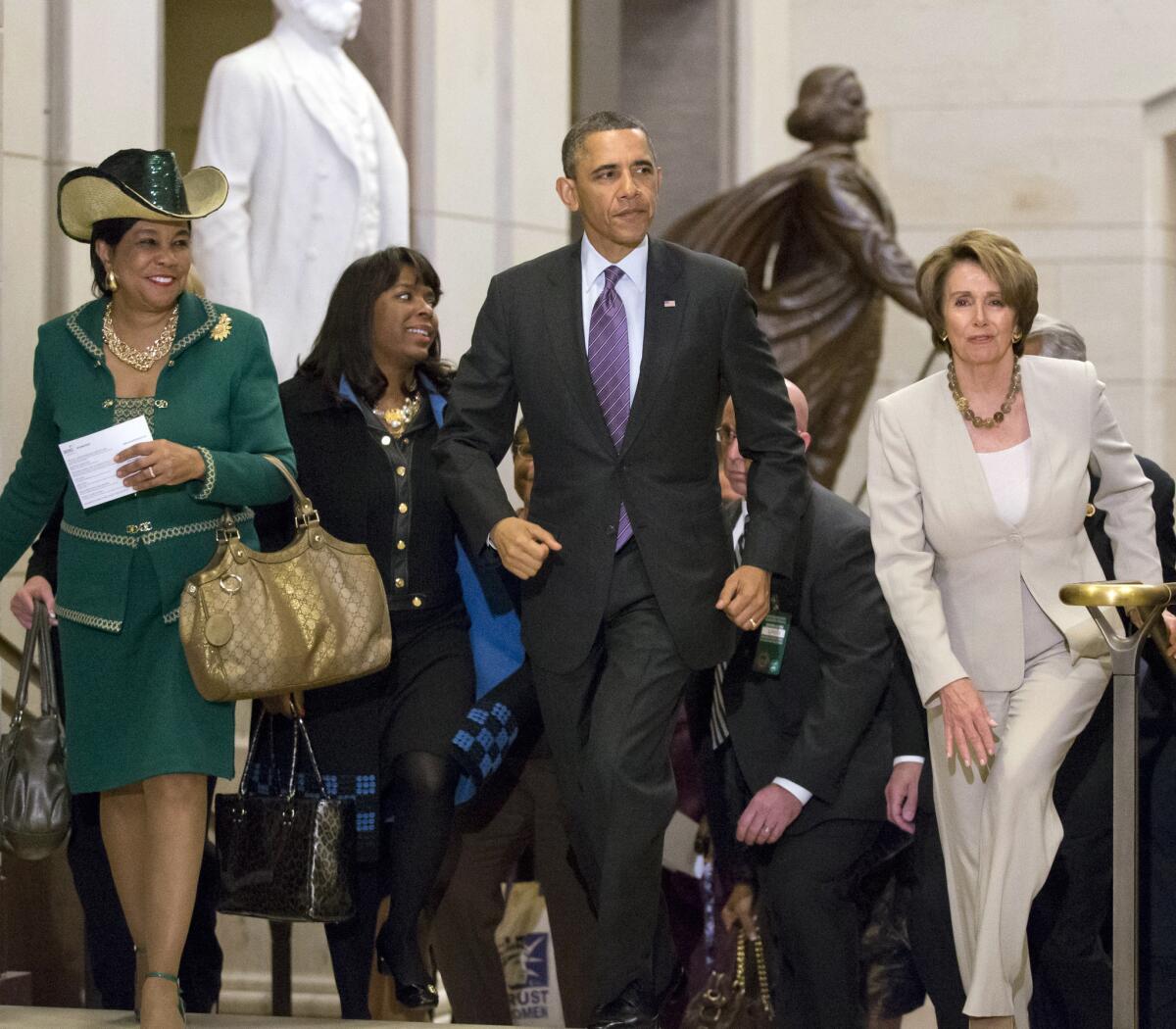 President Obama and House Minority Leader Nancy Pelosi (D-Calif.) leave a meeting with House Democrats at the Capitol in Washington with at far left, Rep. Frederica Wilson (D-Fla) and Rep. Terri Sewell (D-Ala.) second from left.