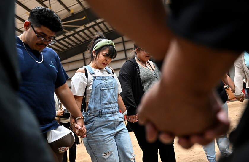 Mourners pray after a vigil at the Uvalde County Fairplex in Texas.