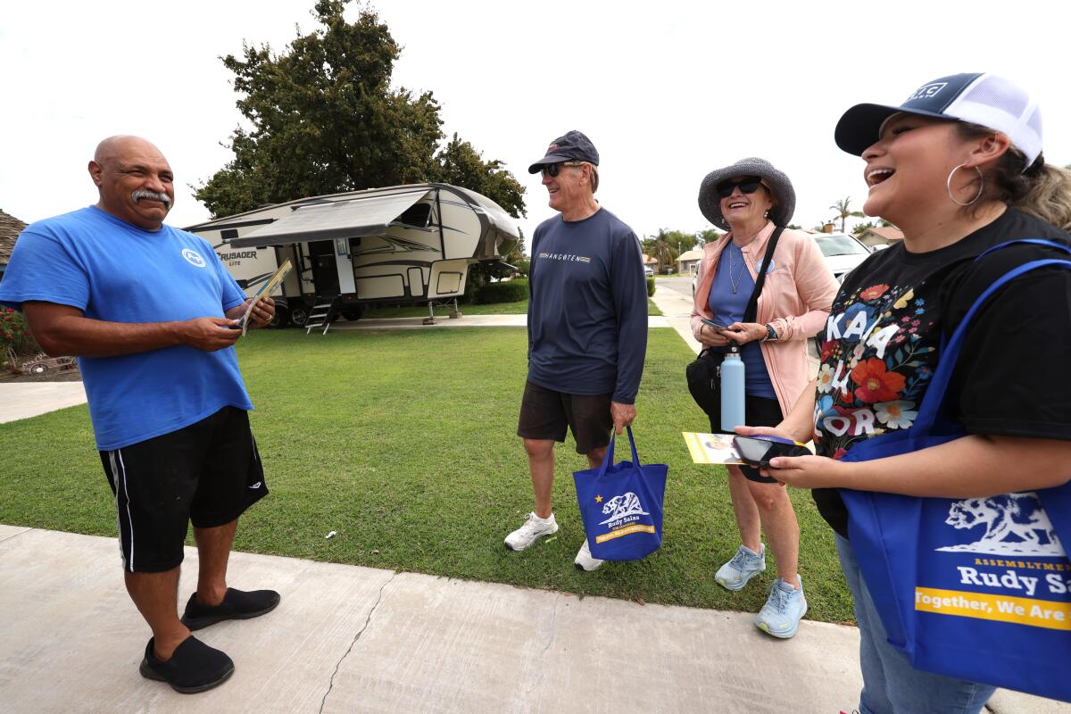 Three people canvassing for Rudy Salas meet with a Wasco resident. 