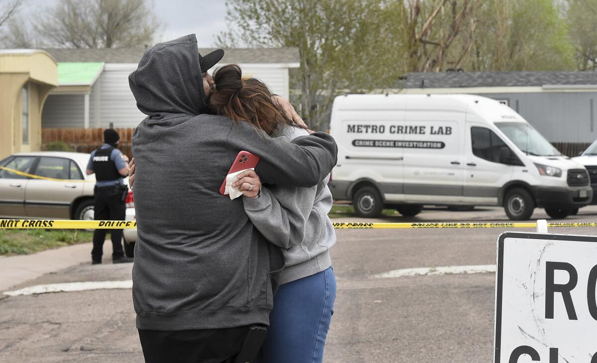 Couple comforting each other after shooting
