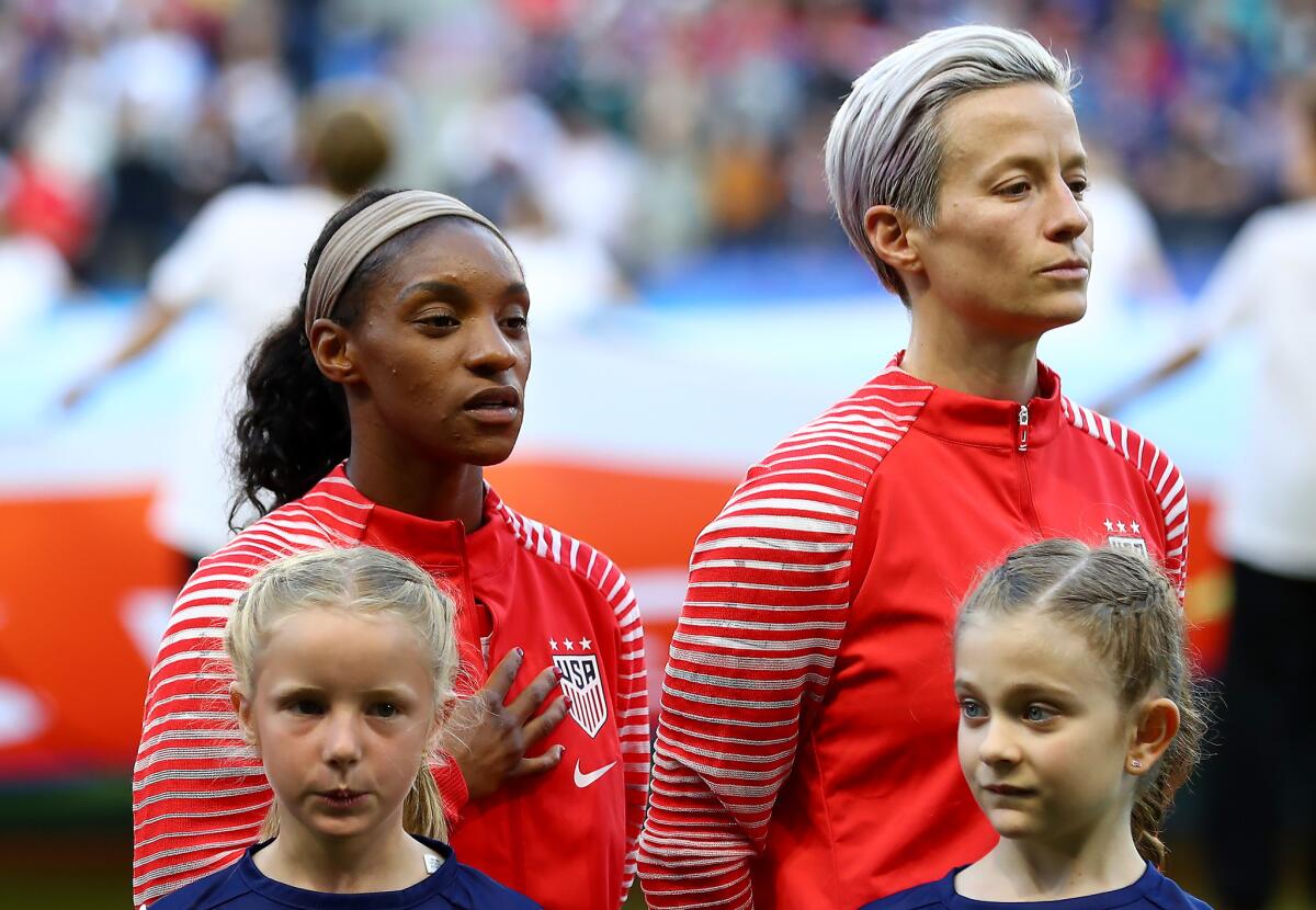Megan Rapinoe stands silently with her hands to her side as the national anthem plays prior to U.S.-Sweden match Thursday in Le Havre, France.