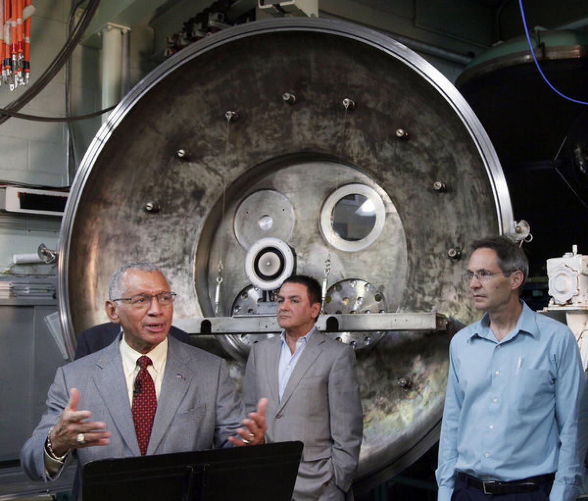 NASA Administrator Charles Bolden, left, is joined by Firouz Naderi, director for solar system exploration, and John Brophy, electric propulsion engineer, during Bolden's visit to the Jet Propulsion Laboratory in Pasadena on Thursday. NASA engineers are developing an ion engine for an asteroid capture mission later this decade.
