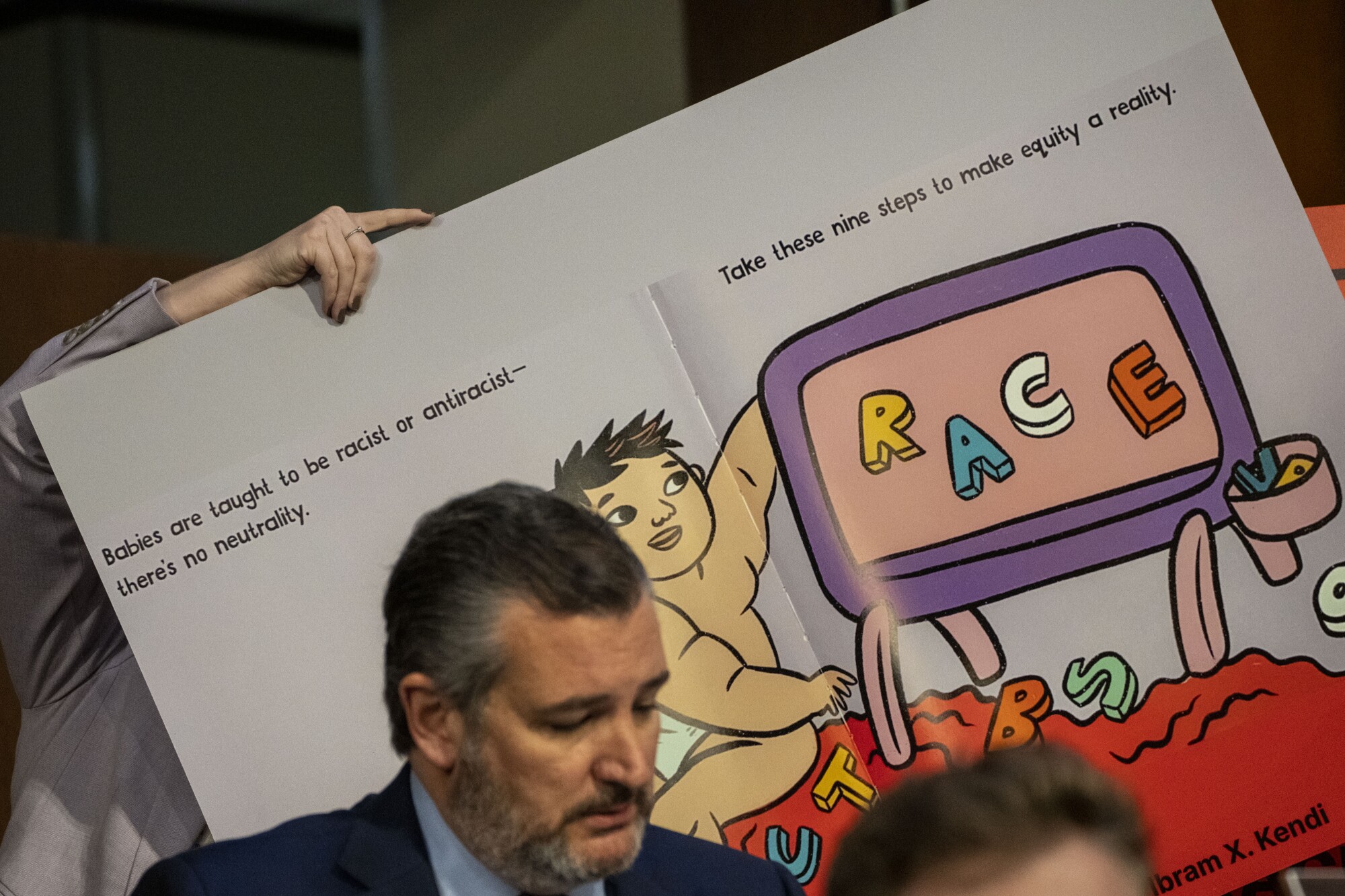A staffer holds up a visual aid for Sen. Ted Cruz as he questions Judge Ketanji Brown Jackson.