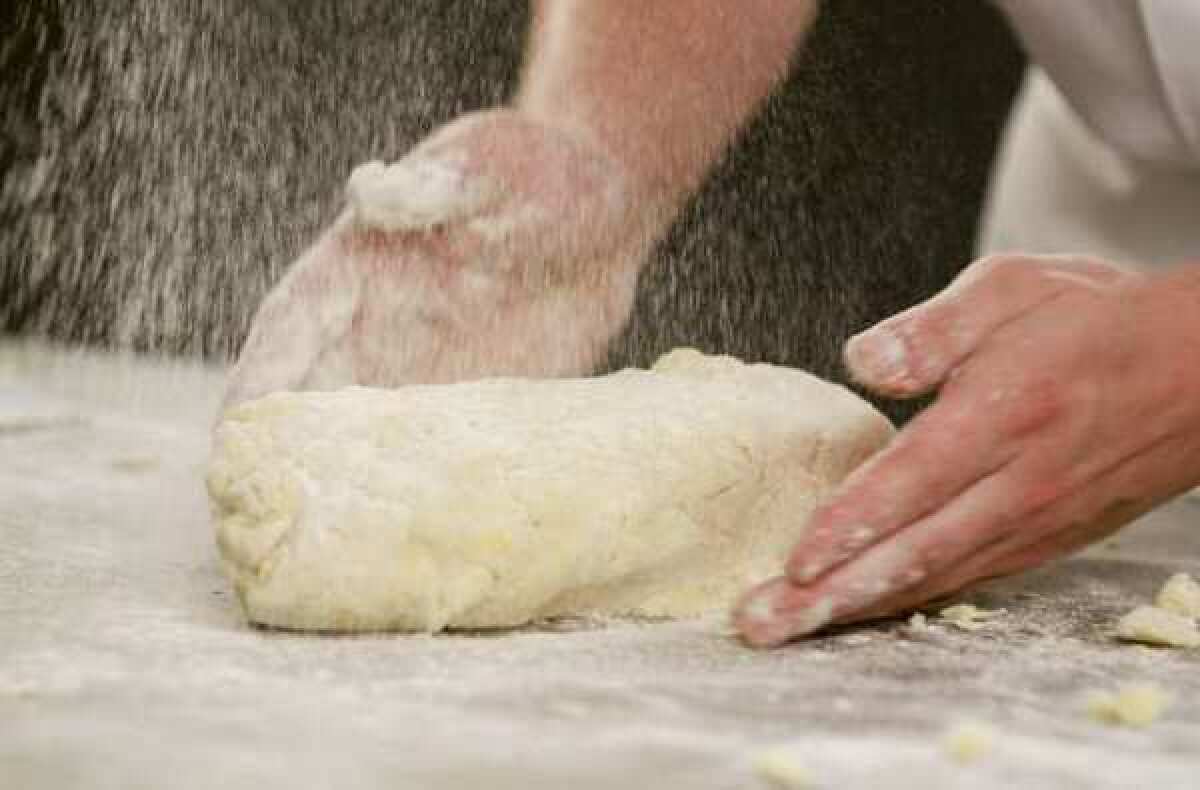 Kneading gnocchi dough on a generously floured surface.