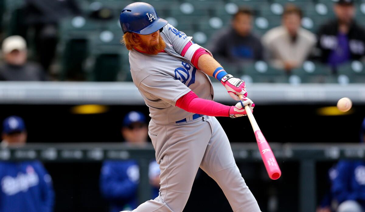 Dodgers third baseman Justin Turner connects for a two-run home run while pinch-hitting against the Rockies in the eighth inning Sunday at Coors Field.