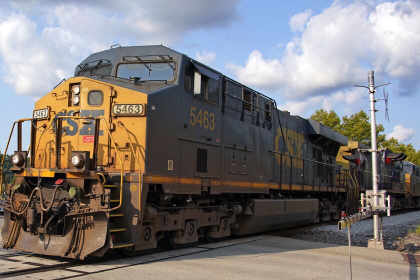 A CSX freight train runs through a crossing in Homestead, Pa., Wednesday, Sept. 14, 2022. (AP Photo/Gene J. Puskar)