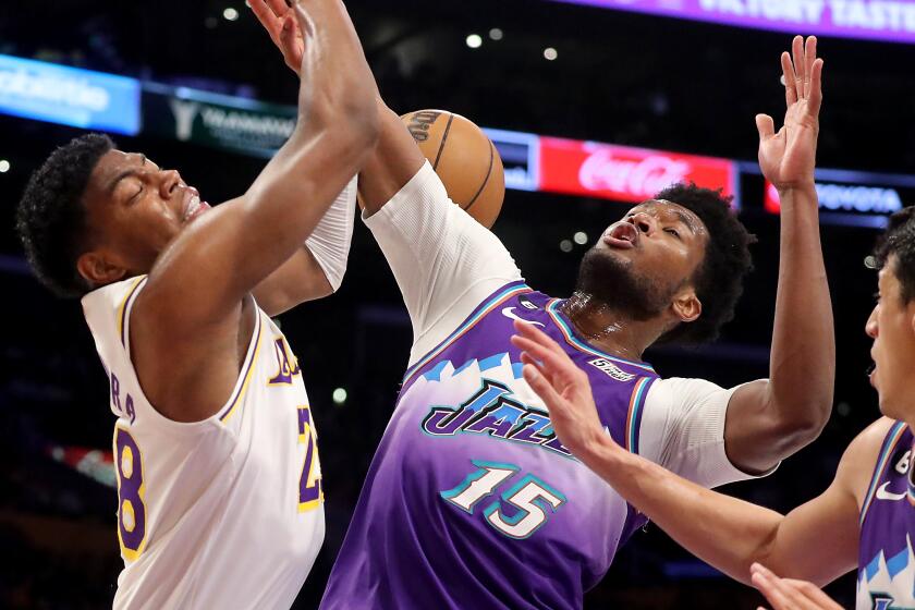 Los Angeles, CA - April 09: Lakers Forward Rui Hachimura, left, battles for a rebound againsty Jazz center Damian Jones.