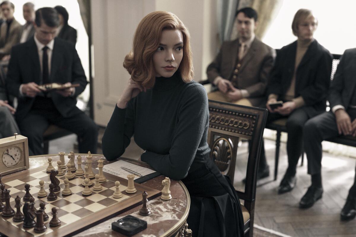 Anya Taylor-Joy sitting in front of a chess board in the Netflix drama "The Queen's Gambit."
