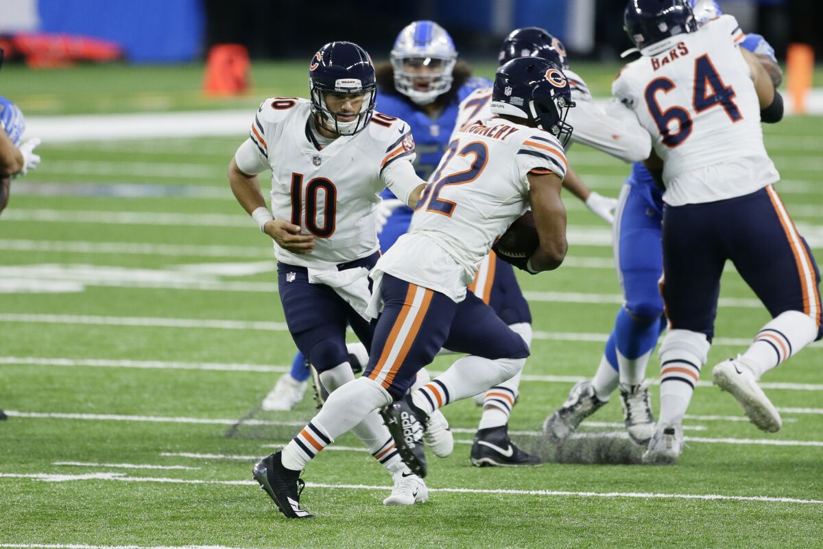 Chicago Bears quarterback Mitchell Trubisky (10) hands off to running back David Montgomery (32) in the second half of an NFL football game in Detroit, Sunday, Sept. 13, 2020. (AP Photo/Duane Burleson)