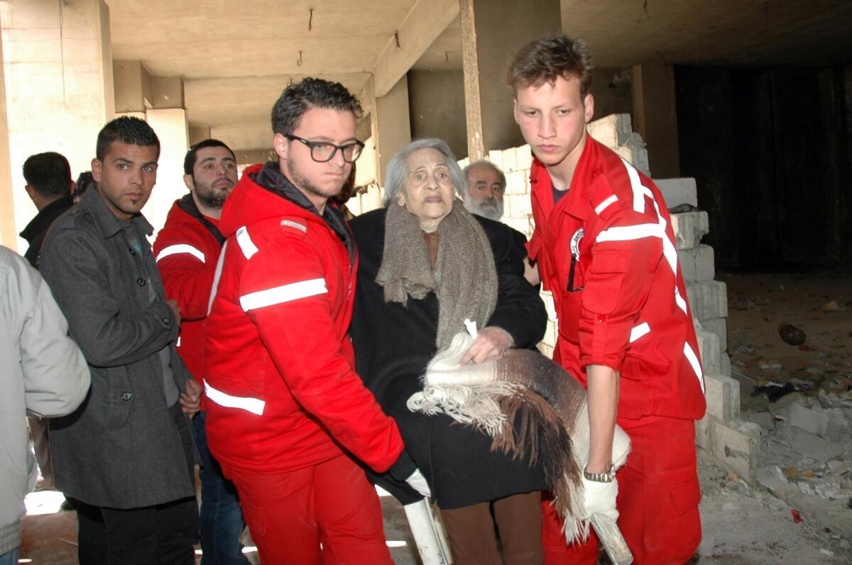 Syrian Red Crescent workers evacuate civilians from Homs.
