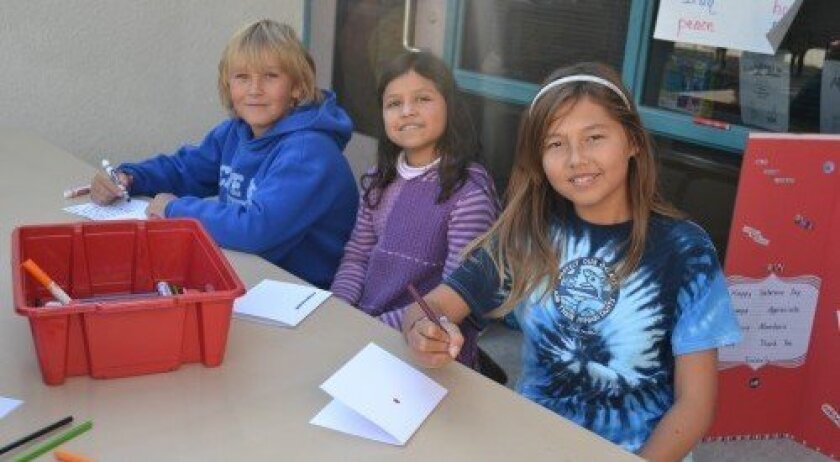 Aidan Davis, Amaya Mirsky and Nicole Foley make cards for veterans. (Photo: Stacy Phillips)