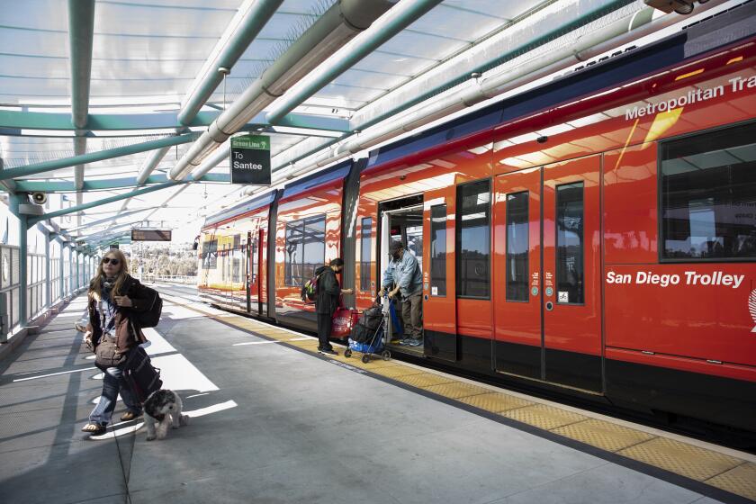 San Diego, California - November 10: People board and get off the San Diego Trolley's green line at the Grantville station on Wednesday, Nov. 10, 2021 in San Diego, California. (Ana Ramirez / The San Diego Union-Tribune)