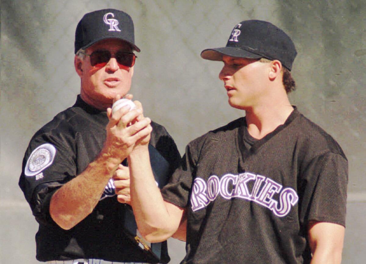 Colorado Rockies pitching coach Frank Funk gives some pointers to Rockies replacement player Barry Goldman in February 1995.