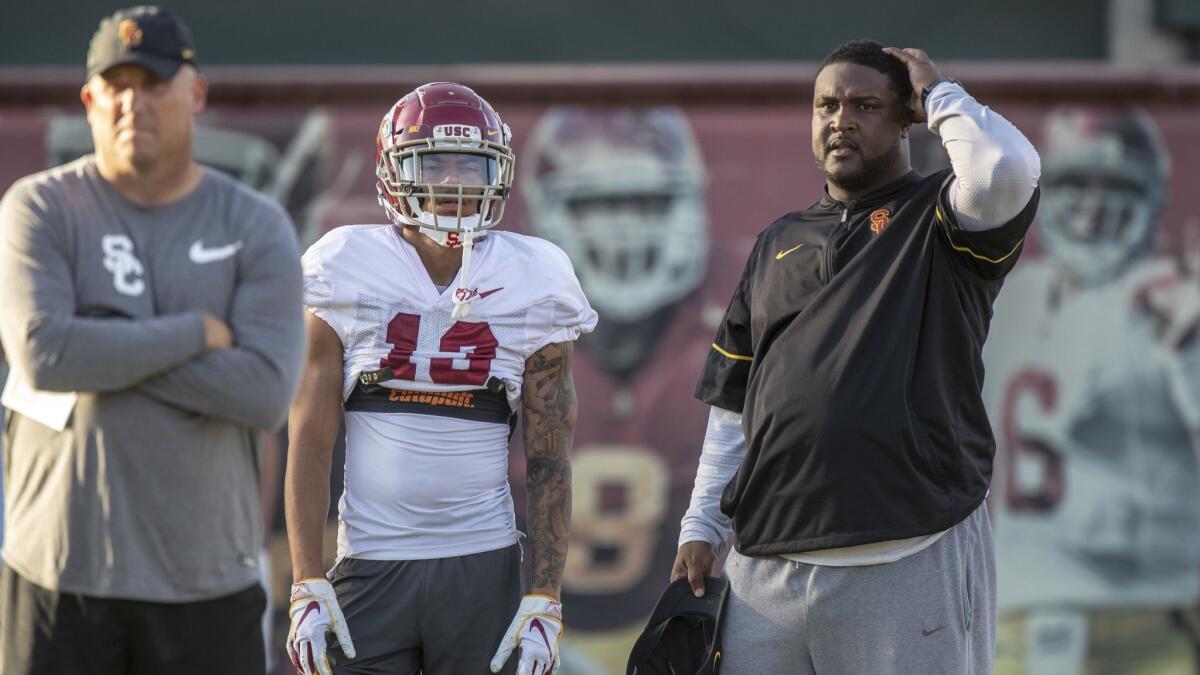 USC football coach Clay Helton, left, and offensive coordinator Tee Martin, right, at practice.